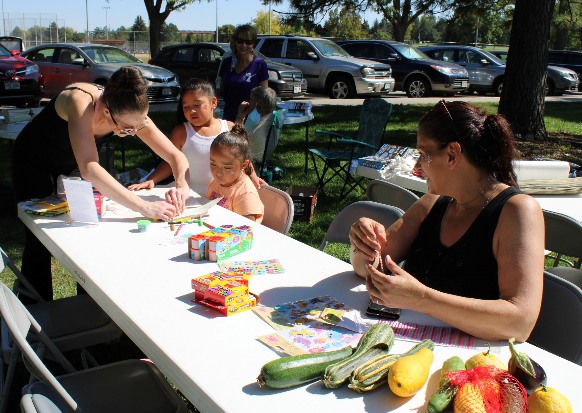 A group of people sitting at a table with food.